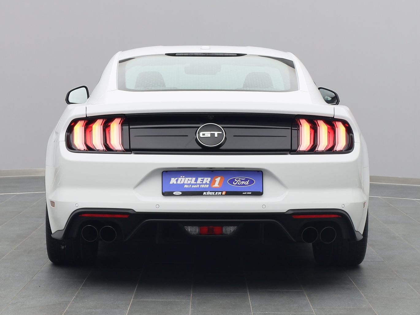 Heckansicht eines Ford Mustang GT Coupé V8 450PS / Premium 2 / Navi / ACC in Liquid Weiss 