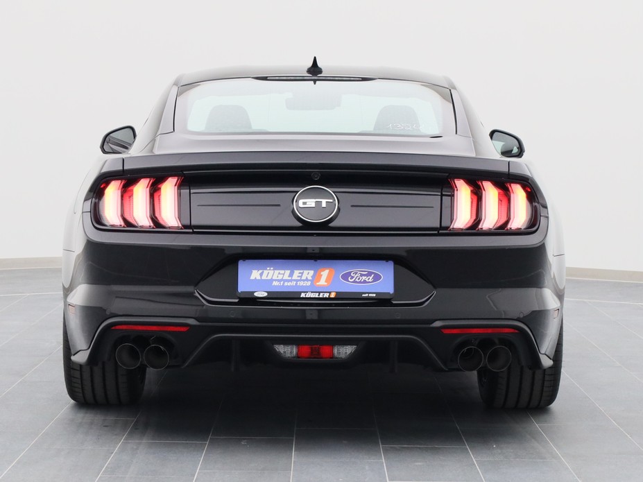 Heckansicht eines Ford Mustang GT Coupé V8 450PS / Premium 2 / B&O in Iridium Schwarz 