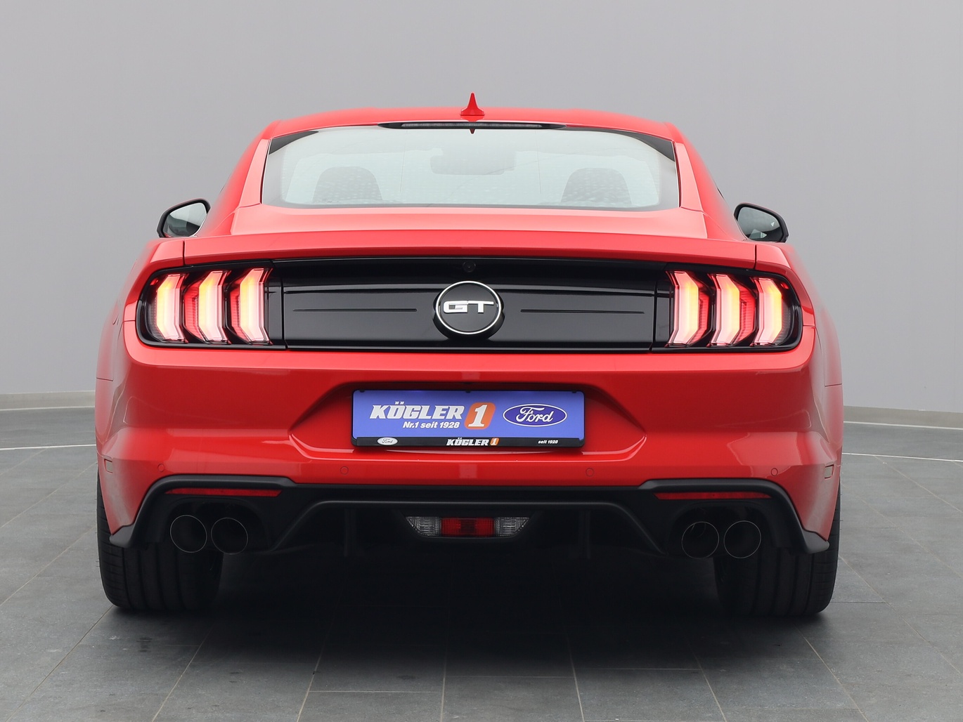 Heckansicht eines Ford Mustang GT Coupé V8 450PS / Premium 2 / Magne in Race-rot 